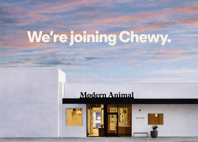 A veterinary practice storefront under a wide banner sky.